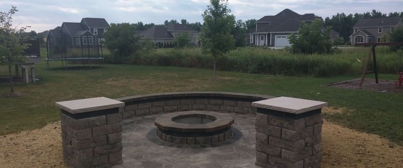 Backyard landscaping with edged beds and a maintained lawn.