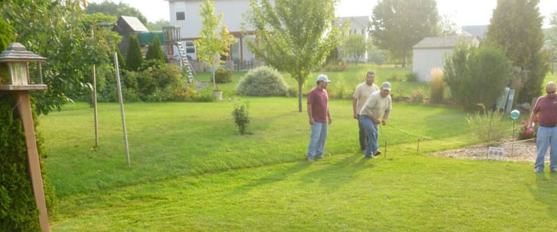 Patio and outdoor living area with surrounding plantings.