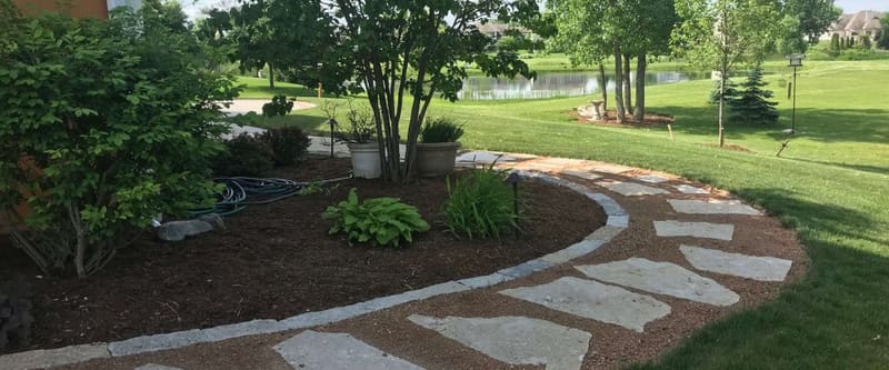 Paver walkway and landscape beds on a completed project.